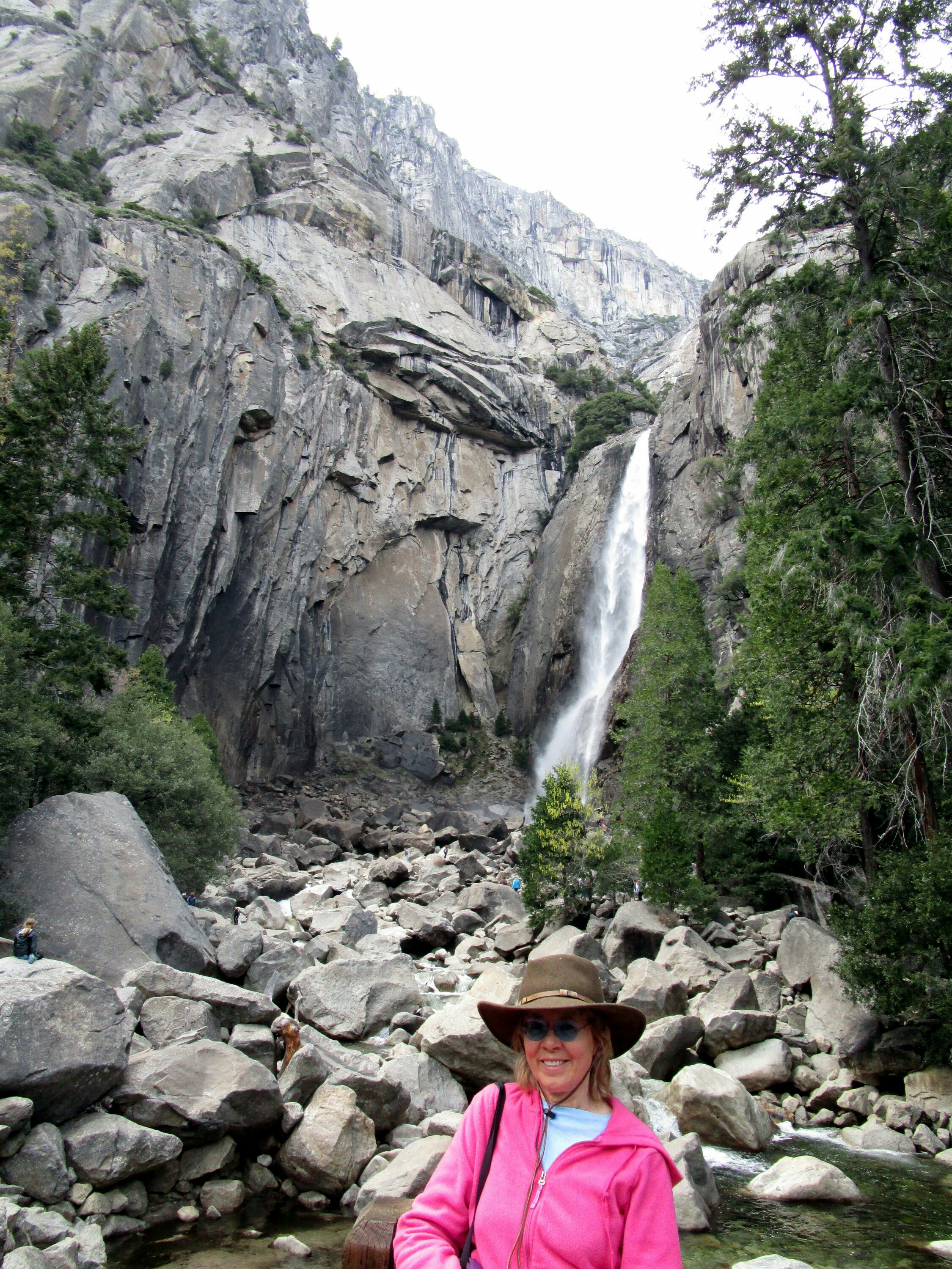 Dr. Renfrew is standing in front of deposited boulders at the base of Yosemite Falls.